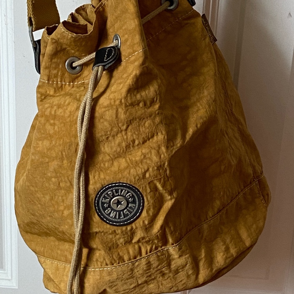 Kipling Crossbody drawstring closure Bag Color: Yellow/gold